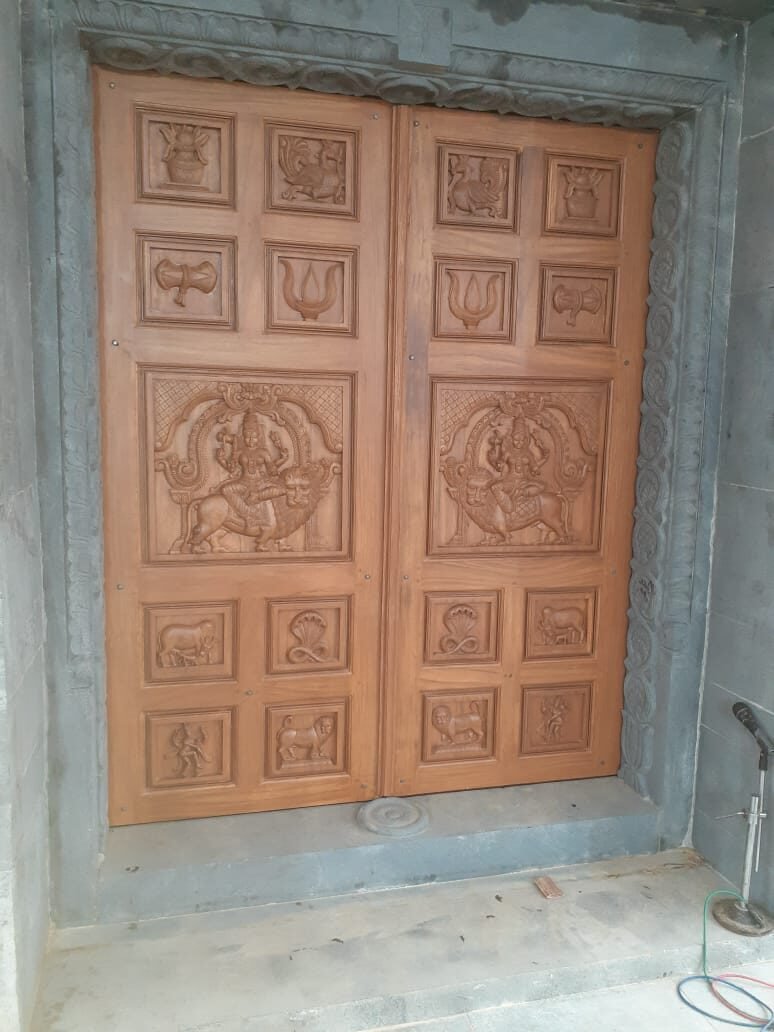 Carved wooden door with deity motifs